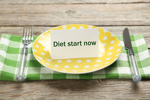 istock Yellow plate on a grey wooden table 533345624