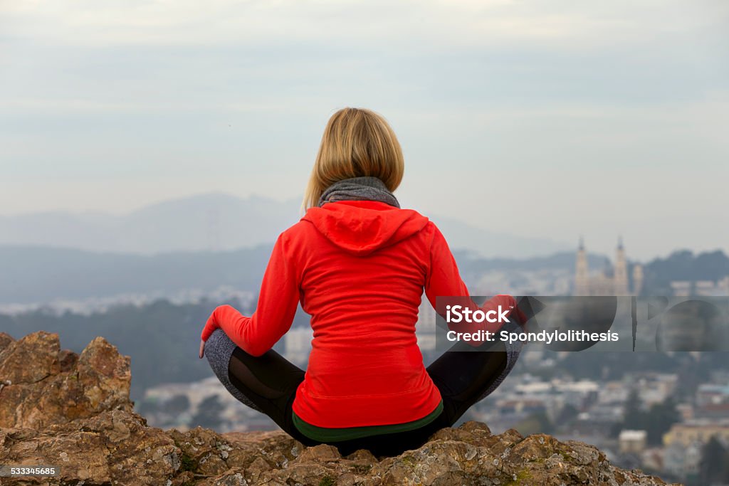 natural balance at San Francisco A beautiful woman is doing Yoga and Pilates at San Francisco. Downtown at background. Winter Stock Photo