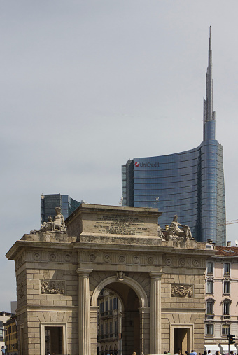 Milan Between history and Modernity. The Porta Nuova ancient arch and the new glass skyscraper behind it on May 10 2014