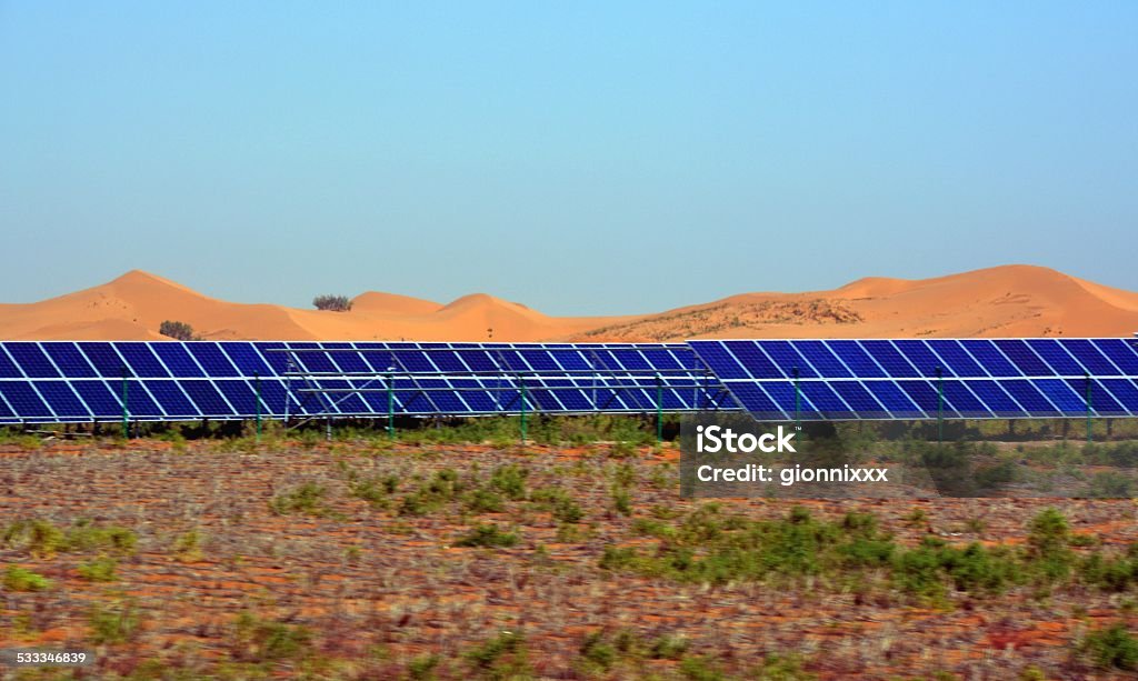 Photovoltaic panels, Tengger desert Inner Mongolia photovoltaic power plant in the southern part of Tengger desert, near Zhongwei, Ningxia. The industrial park planning area is developing to ​​6.5 acres, The area will be the country's largest photovoltaic power plant . Desert Area Stock Photo