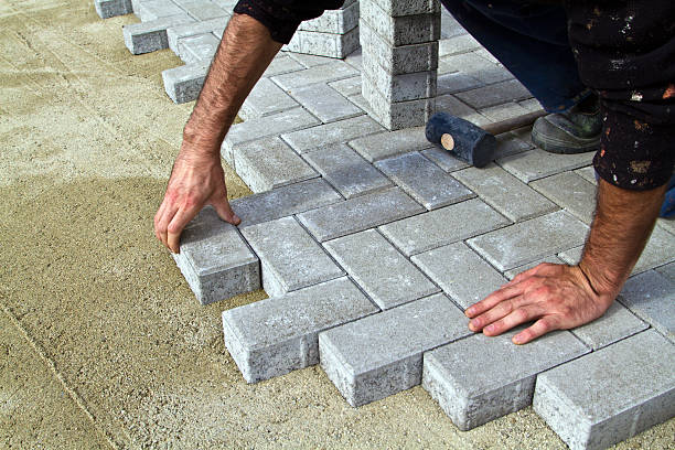 Construction of pavement Construction of pavement. Worker puts paving driveway stock pictures, royalty-free photos & images