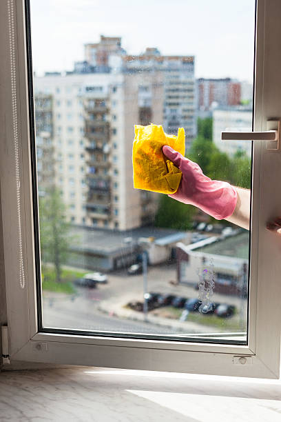 istock washer cleans window by rag in apartment house 533346934