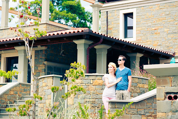 istock young couple in front of their large villa 533347029