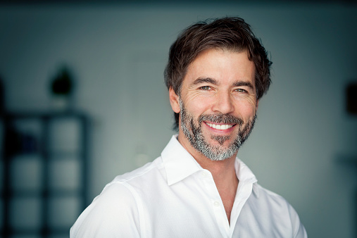 Close Up Of A Mature Man Smiling At The Camera