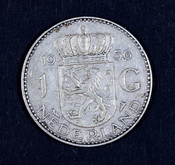 Silver dutch coin Front of the 1 guilder coin,  Isolated on black dutch guilders stock pictures, royalty-free photos & images