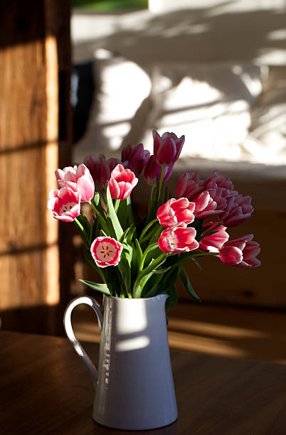 istock Pitcher of flowers on a table. 533349415