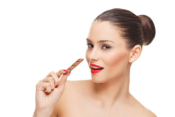 istock Young beautiful woman biting a chocolate bar 533350401