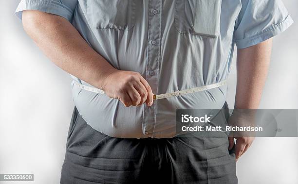 Obese Man Measuring His Waist Stock Photo - Download Image Now - Body Conscious, Adult, Healthy Lifestyle