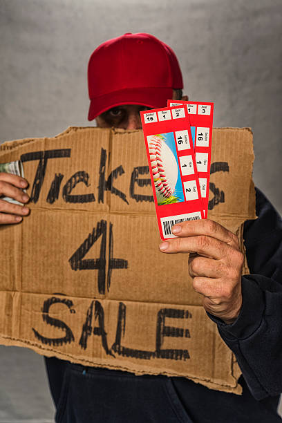istock Shady character scapling a pair of baseball game tickets 533351058