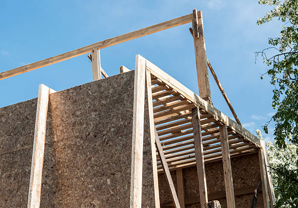 istock New residential construction home against a blue sky. 533351736