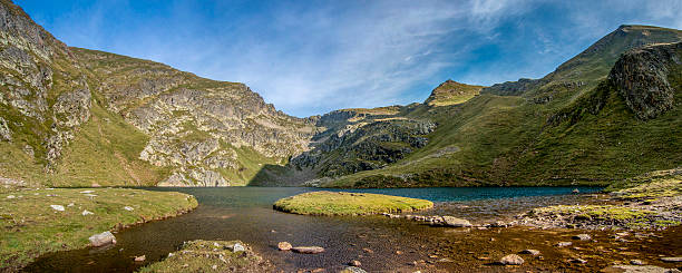 Mountain lake with a small island Pyrenees mountains with a lake and a small island in the middle. High-resolution panoramic image at sunset. green mountains appalachians photos stock pictures, royalty-free photos & images