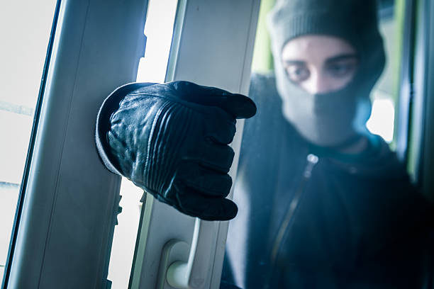 Burglar Breaking Into House Burglar Breaking Into House burglary crowbar stock pictures, royalty-free photos & images