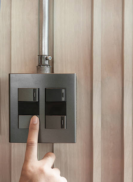 istock grey or black metallic light switch on wooden background. 533353554
