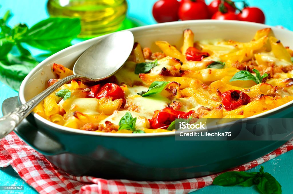 Baked pasta bolognese. Baked pasta bolognese on a blue background. Baked Stock Photo