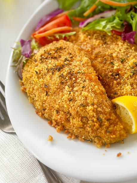 istock Breaded and Baked Fish Fillets with side Salad 533355142
