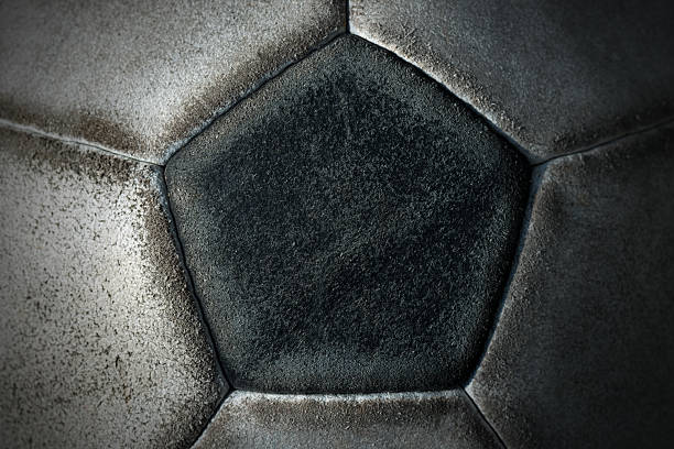 Detail of an Old Soccer Ball Macro photo of an old black and white soccer ball with pentagons and hexagons in leather old football stock pictures, royalty-free photos & images