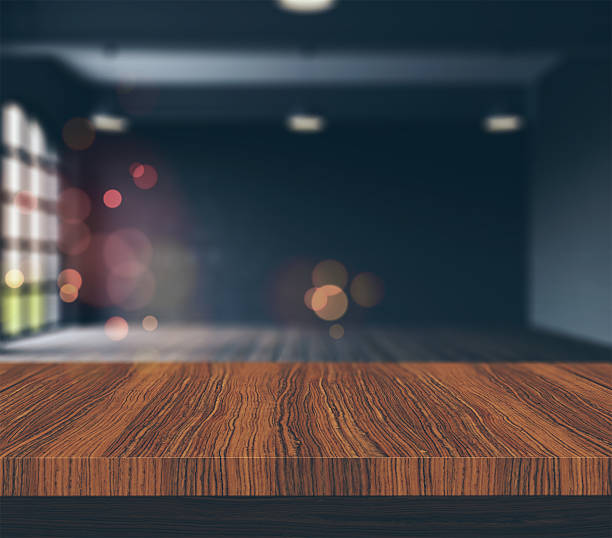 istock 3D wooden table looking to a defocussed empty room 533357742