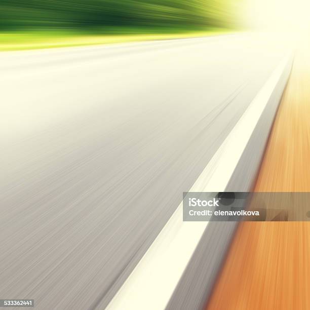 Country Road In Motion Blur And Sunlight Stock Photo - Download Image Now - 2015, Activity, Asphalt