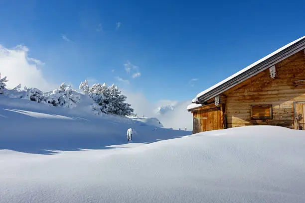 snow-covered ski hut in the Alps