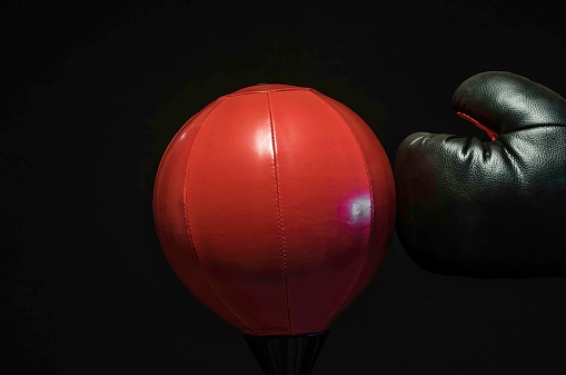boxer punching a swing ball, studio isolated, colour image