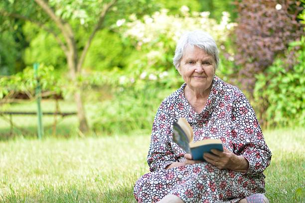 istock Senior woman reading book in park. 533363545