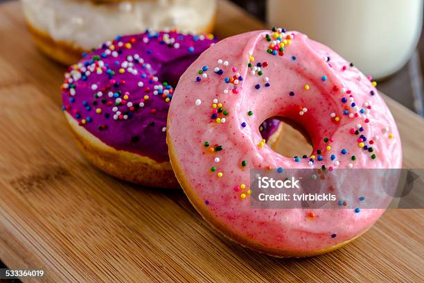 Fresh Baked Vanilla Bean Iced Doughnuts Stock Photo - Download Image Now - 2015, Baked, Bakery