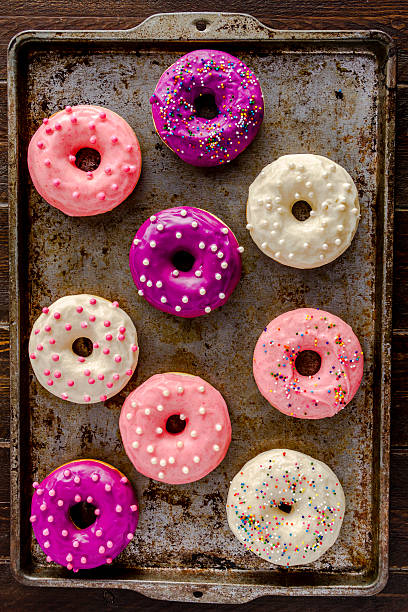 istock Fresh Baked Vanilla Bean Iced Doughnuts 533364403