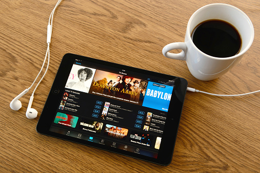 İstanbul, Turkey - January 19, 2015: Apple iPad Mini displaying iTunes store on a desk. The iPad Mini produced by Apple Inc.