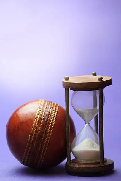 Hourglass and cricket ball.