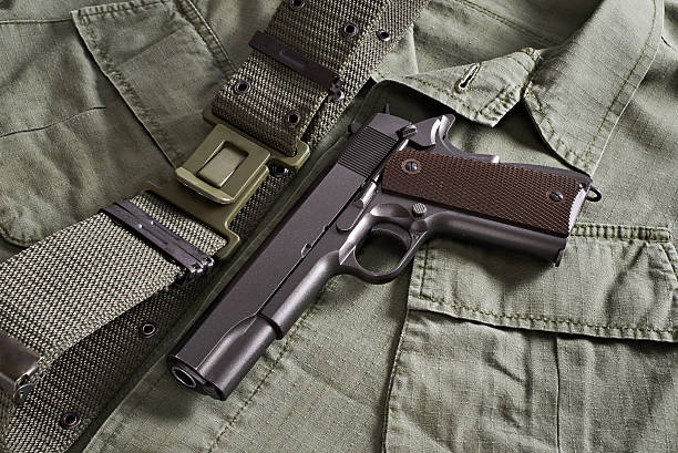 istock Colt pistol and belt lie on military jacket 533375565