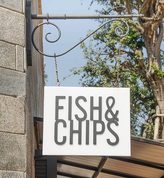 Fish and chip sign hang on wall stock photo