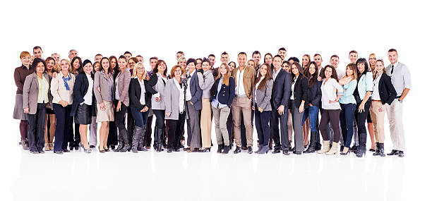 Large group of business people. Large group of mixed-age business people standing together and looking at the camera. Isolated on white. large group of people facing camera stock pictures, royalty-free photos & images