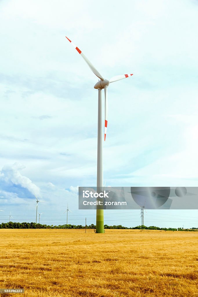 Wind turbines Wind turbines in cultivated field, copy space 2015 Stock Photo