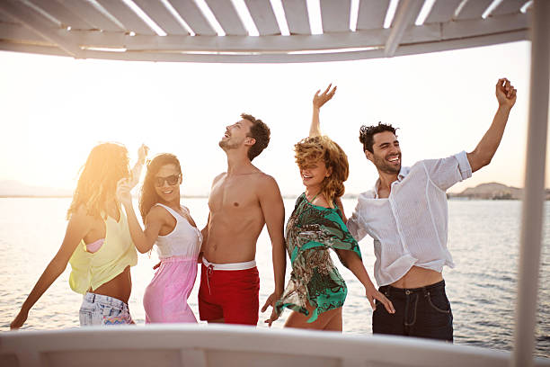 istock People dancing on a boat at sunset. 533398089