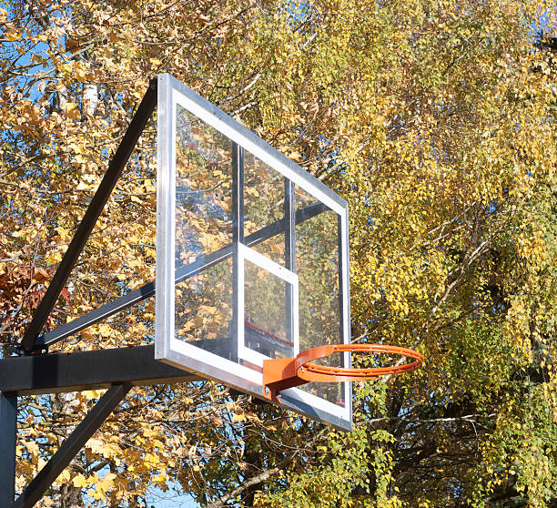 A basketball hoop which through it you can see the sky.