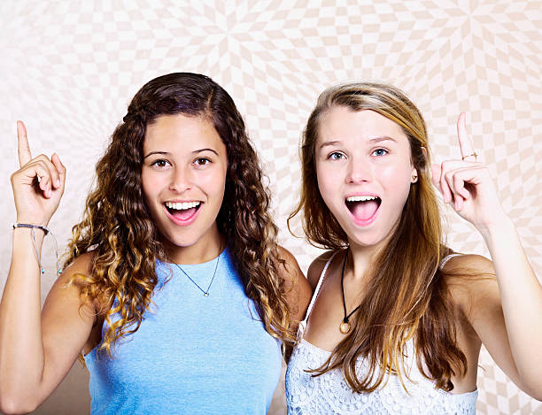 istock We got it! Two smiling young women pointing upwards 533398969