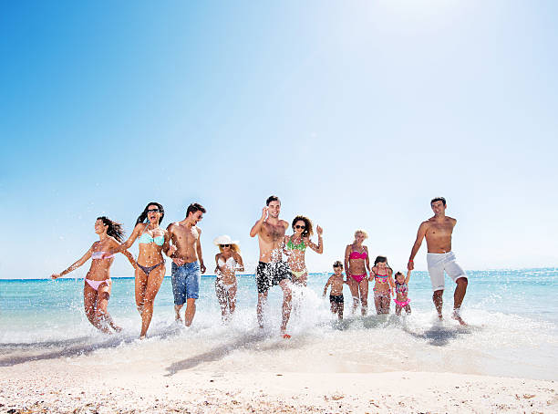 istock Large group of people running on the beach. 533398973