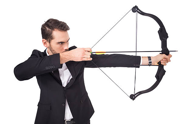 istock Elegant businessman shooting bow and arrow 533399257