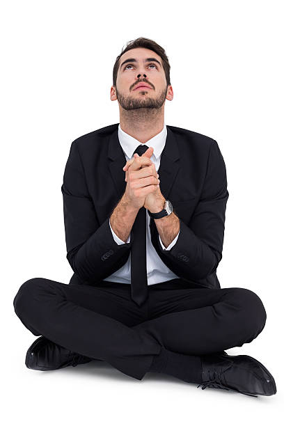 istock Businessman sitting praying and looking up 533399567