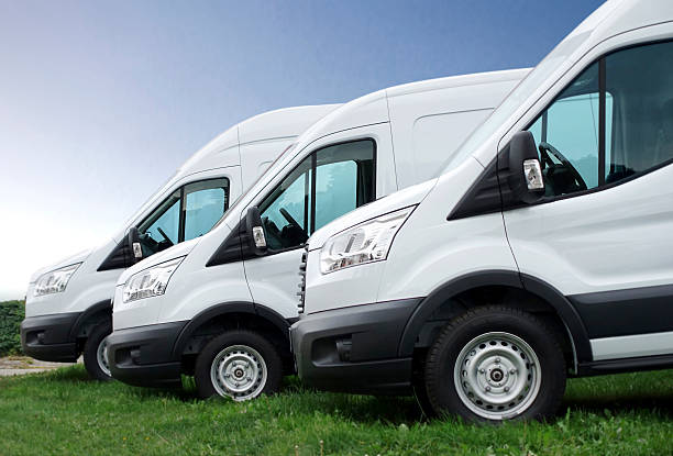 istock White vans in a row against blue sky 533400539