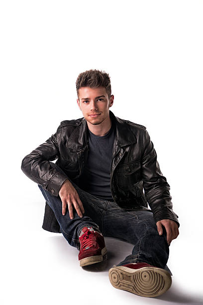 istock Attractive young man with leather jacket sitting on the floor 533401771