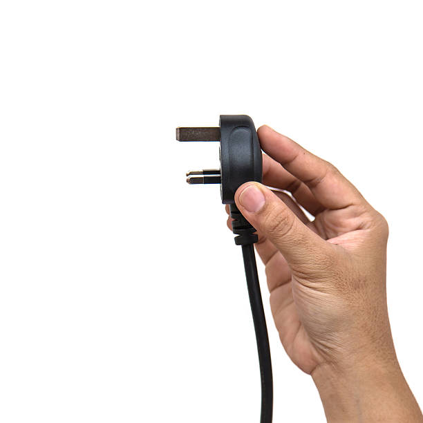 istock Hand holding electric plug isolated on white background 533402237