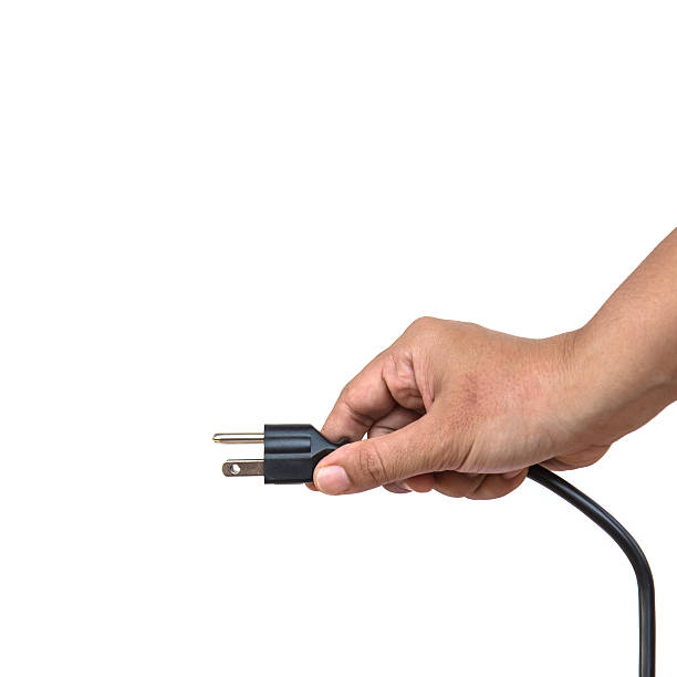 istock Hand holding electric plug isolated on white background 533402243