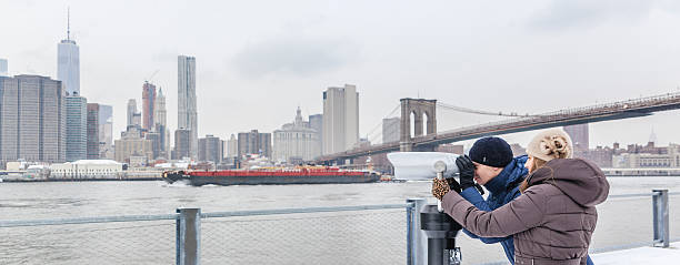 istock Young  man, tourist, looking to Manhattan with binocular 533421239