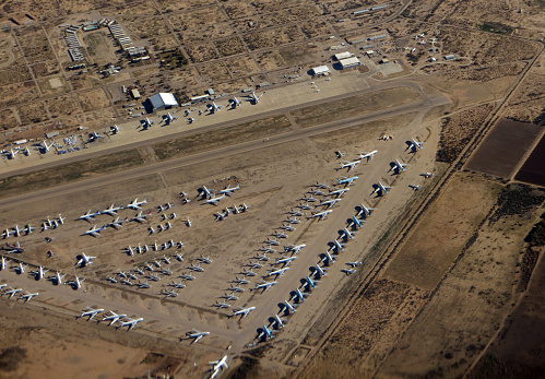 Aircraft boneyard commercial jets parked in the desert.
