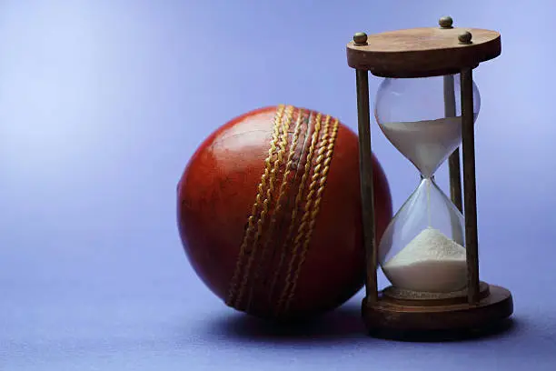 Hourglass and cricket ball.