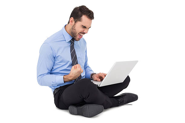istock Cheering businessman sitting using his laptop 533421755