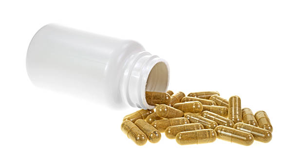istock Bottle of green tea extract capsules spilling 533423441