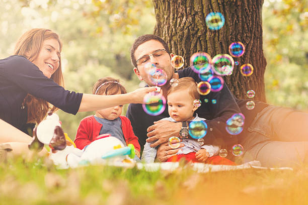 istock Happy family playing with soap baubles 533425285