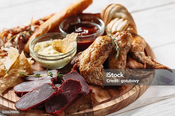 Meat Beer Snacks On White Plate Stock Photo - Download Image Now - Appetizer, Barbecue - Meal, Barbecue Grill